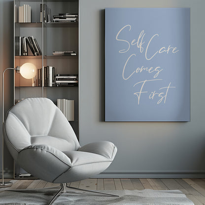 A framed poster featuring the phrase 'Self Care Comes First' in an elegant, off-white cursive font against a solid light blue background. The artwork is enclosed in a simple black frame. Decor