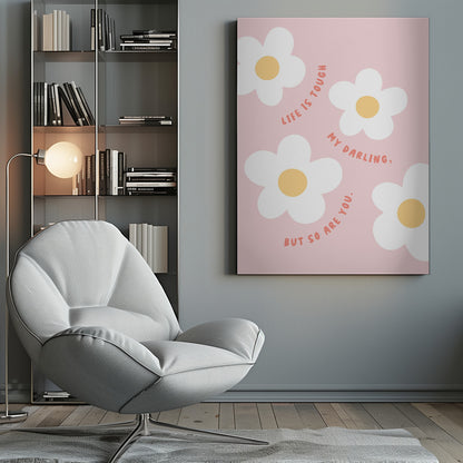 A motivational art print with a light pink background featuring four simple, stylized white daisies with yellow centers. The quote 'Life is tough my darling, but so are you.' is written in a playful, reddish-orange handwritten font that curves around the flowers. Artwork