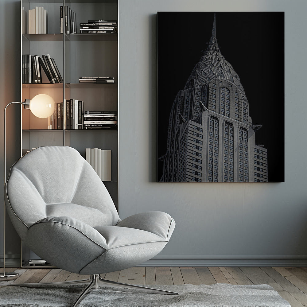 A dramatic, low-angle, black and white photograph of the top of the Chrysler Building, showcasing its iconic Art Deco spire and architectural details against a solid black background. Decor