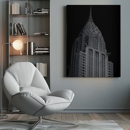A dramatic, low-angle, black and white photograph of the top of the Chrysler Building, showcasing its iconic Art Deco spire and architectural details against a solid black background. Decor