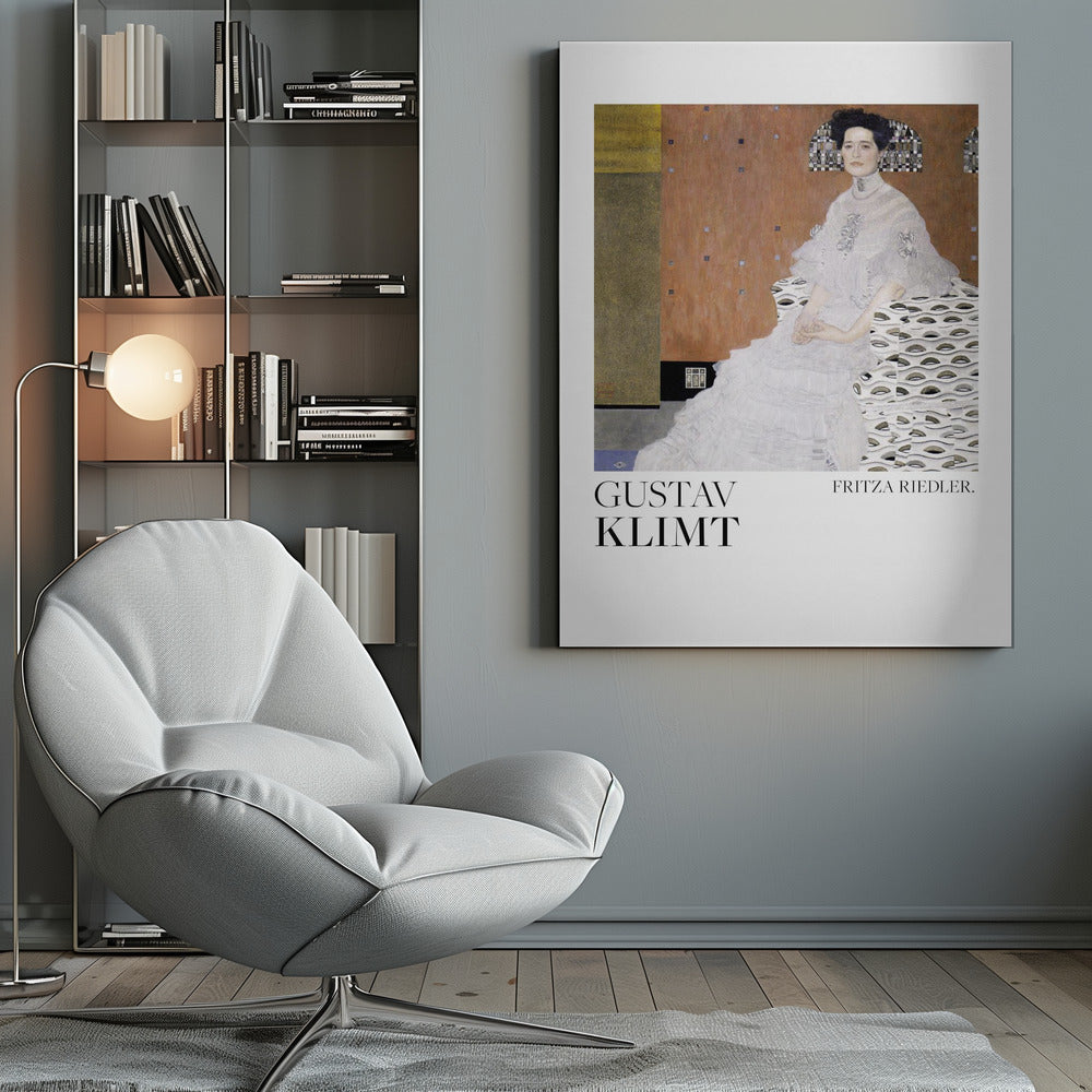 A framed art print of Gustav Klimt's 1906 painting, 'Portrait of Fritza Riedler'. A woman with dark, upswept hair wearing a detailed, high-necked white gown sits in a patterned chair against a warm, textured brown and gold background. Below the artwork, on a white border, the text 'GUSTAV KLIMT' and 'FRITZA RIEDLER.' is printed. Print