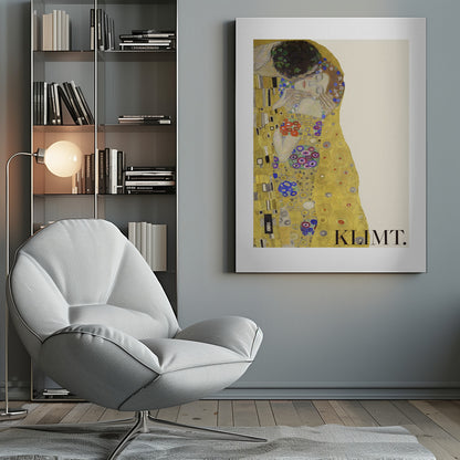 A framed art print of Gustav Klimt's 'The Kiss'. A couple embraces in ornate golden robes against a shimmering gold background. The poster includes the artist's name 'KLIMT.' in the lower right. Decor