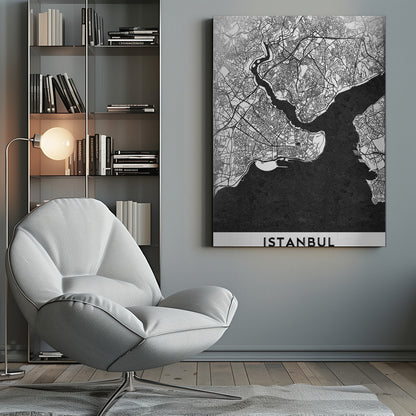 A modern black and white framed poster of a city map of Istanbul. The land is depicted in white with intricate black lines representing streets, while the bodies of water like the Bosphorus are shown in solid textured black. A white banner at the bottom displays the word 'ISTANBUL' in a bold, black, sans-serif font. Artwork