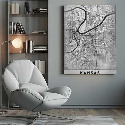 A modern, black and white line-art map of Kansas City, displayed in a black frame. The map details the intricate grid of streets and the winding path of a major river. At the bottom, a white border contains the word 'KANSAS' in bold, black capital letters. Artwork