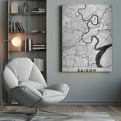 A minimalist black and white map poster of Saigon, Vietnam, displayed in a black frame. The map highlights the winding Saigon River in solid black against a white background with a complex grid of roads and smaller waterways in thin black lines. At the bottom, a white border contains the word 'SAIGON' in bold, black, capital letters. Wall Art