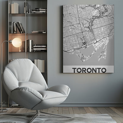 A modern, black and white poster featuring a stylized street map of Toronto, Canada. The map is in a black frame, and the word 'TORONTO' is written in bold, black, distressed letters at the bottom. Print