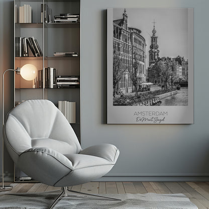 A black and white travel poster of Amsterdam, Netherlands. The photo shows the Munttoren clock tower and traditional Dutch buildings along the Singel canal. A floating barge filled with bicycles is in the foreground. The poster has a white border with the text 'AMSTERDAM', 'De Munt, Singel', and 'NEDERLAND' at the bottom. Artwork