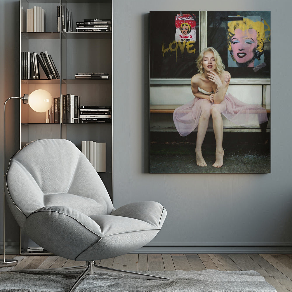 A blonde woman styled like Marilyn Monroe sits on a bench, wearing a pink tulle skirt. Behind her, a dark window features an Andy Warhol-style poster of Monroe, a Campbell's soup can parody, and the word 'LOVE' in gold graffiti. Artwork