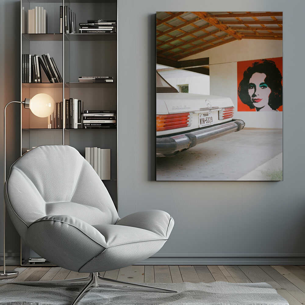A film-style photograph showing the rear of a classic white Mercedes-Benz parked under a carport with exposed wooden beams. On the adjacent white wall hangs a vibrant red pop-art portrait of a woman with dark hair. Artwork