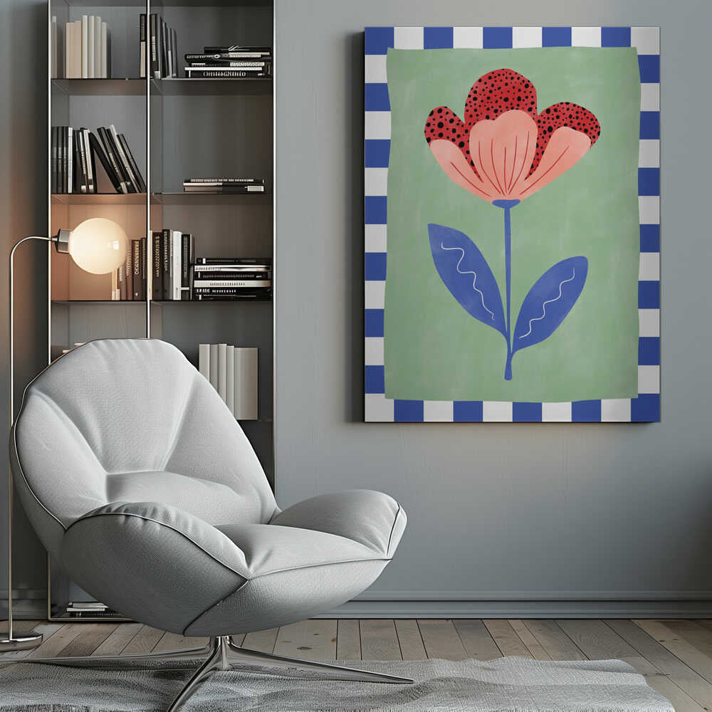 A framed illustration of a stylized flower with red polka-dotted and pink petals. The flower has a blue stem and two blue leaves, set against a sage green background with a blue and white checkered border. Artwork