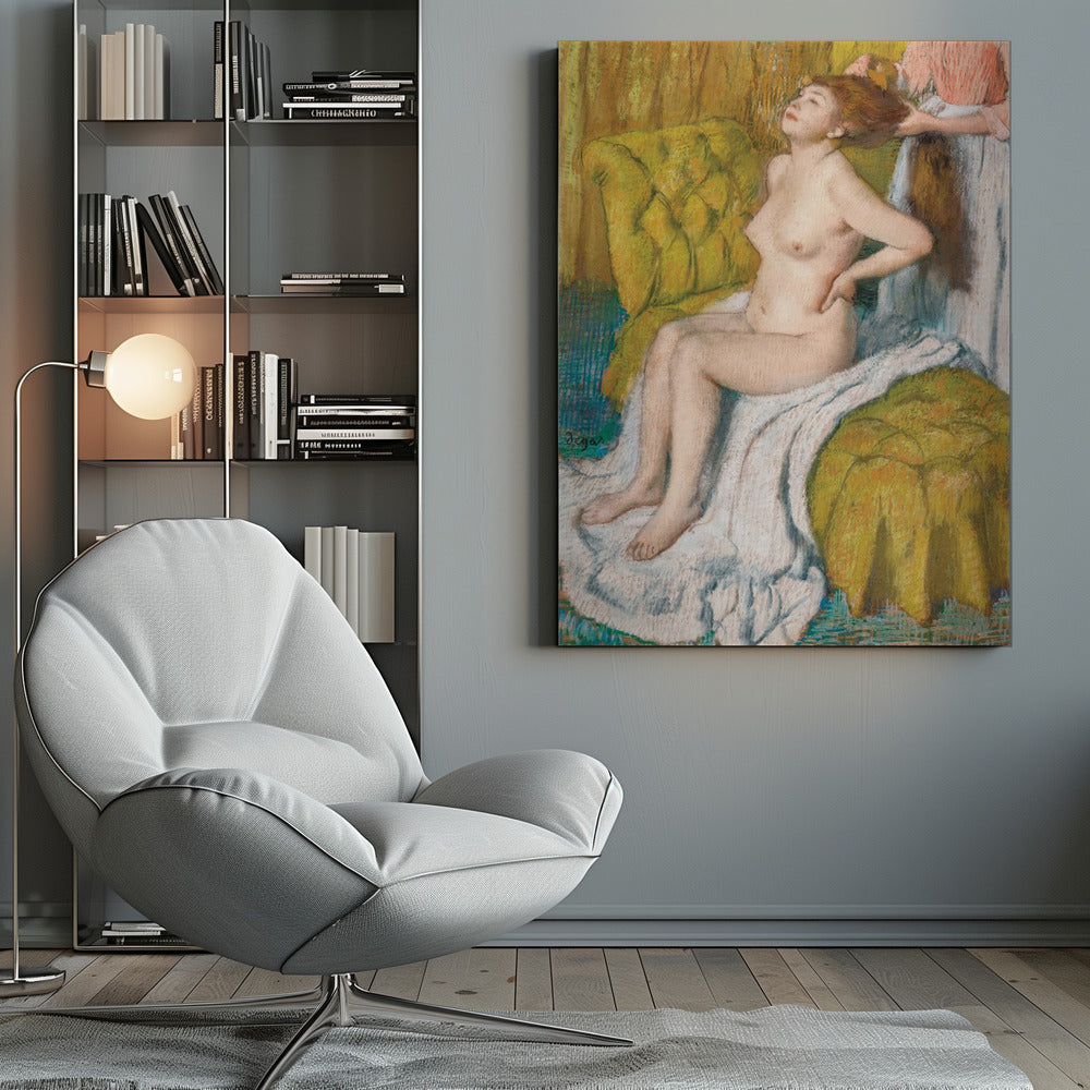 A pastel drawing by Edgar Degas of a nude woman with red hair sitting on a plush, chartreuse armchair. She leans her head back in pleasure as another person, likely a maid, stands behind her and combs her hair. The scene is intimate and rendered in an impressionistic style with visible pastel strokes. Artwork