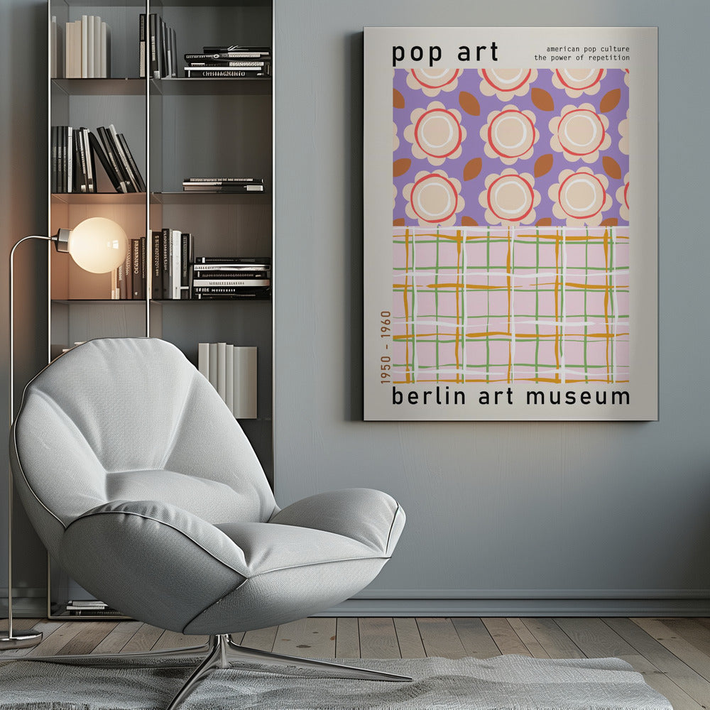 A framed pop art museum poster advertising an exhibition at the Berlin Art Museum. The poster features two distinct patterns. The top section has repeating stylized cream and red flowers on a purple background, with the words 'pop art' and 'american pop culture the power of repetition'. The bottom section displays a pink, green, and orange plaid pattern. The dates '1950 - 1960' are printed vertically on the side. Artwork