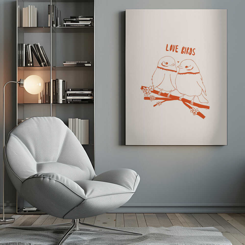 A framed art print featuring a minimalist, reddish-orange illustration on a cream background. Two cartoonish, plump birds sit close together on a flowering branch, looking at each other affectionately. Above them, the text 'LOVE BIRDS' is written in a playful, rounded font. Decor
