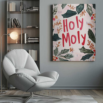 A watercolor-style Christmas-themed artwork with the phrase 'Holy Moly' hand-painted in bold red letters in the center. The text is framed by a loose arrangement of dark green holly leaves, red and orange berries, and small brown sprigs against a light cream and pink background. The artwork is shown in a thin black frame. Artwork