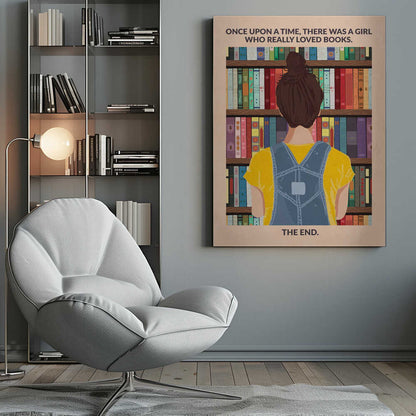 An illustrated poster with a vintage feel, showing the back of a girl with brown hair in a bun, wearing a yellow shirt and blue overalls. She is looking at a tall bookshelf filled with colorful books. Text at the top reads 'ONCE UPON A TIME, THERE WAS A GIRL WHO REALLY LOVED BOOKS.' and text at the bottom reads 'THE END.' The poster is enclosed in a black frame. Artwork
