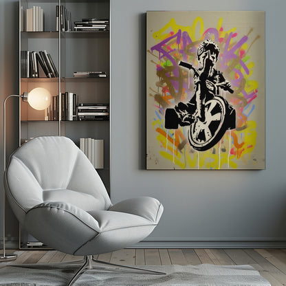 A framed street art piece featuring a black and white stencil of a rebellious child on a tricycle giving the middle finger, set against a vibrant, multi-colored graffiti background with paint drips. Artwork