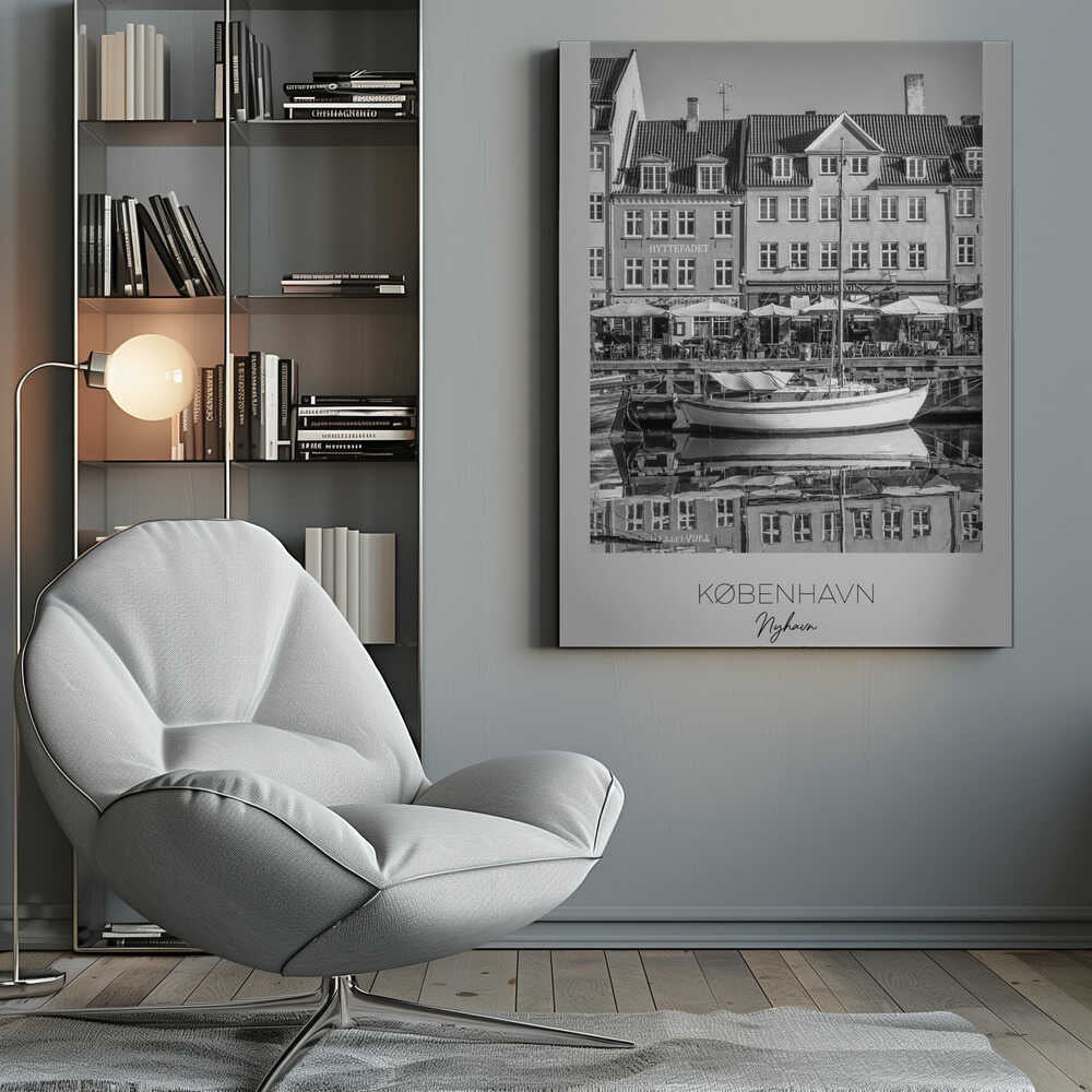 A black and white framed poster of Nyhavn in Copenhagen. The photograph features classic Danish buildings lining a canal, with a sailboat moored in the water. The buildings and boat are perfectly reflected in the still water. At the bottom, text reads 'KØBENHAVN', 'Nyhavn', and 'DANMARK'. Wall Art