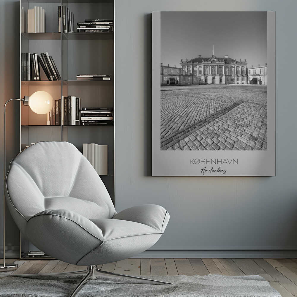 A framed, vertical black and white photograph of Amalienborg Palace in Copenhagen. The shot is taken from a low angle, emphasizing the large cobblestone square in the foreground. The palace stands symmetrically in the background under a clear sky. At the bottom of the poster, text reads 'KØBENHAVN', 'Amalienborg', and 'DANMARK'. Poster