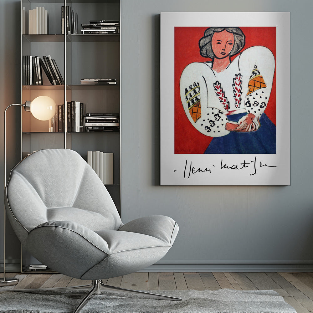 A framed art print of Henri Matisse's 'La Blouse Roumaine' (The Romanian Blouse). The painting depicts a woman with dark, styled hair against a vibrant solid red background. She is wearing a voluminous white blouse with puffy, intricately decorated sleeves and a dark blue skirt. Her hands are clasped in front of her. Below the image is the signature 'Henri Matisse'. Wall Art