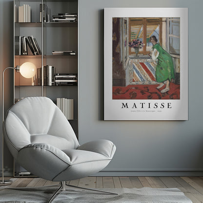 A framed art print of Henri Matisse's painting 'Jeune Fille à la Mauresque - 1939'. The painting shows a woman in a vibrant green dress standing in a room and looking out of an open window with shutters. A red patterned rug covers the floor, and a vase of flowers sits on the windowsill. Poster