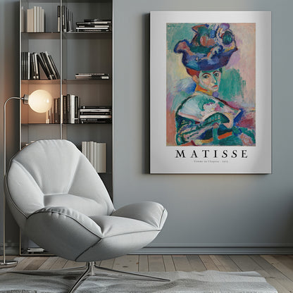 A framed art print of Henri Matisse's famous 1905 Fauvist painting, 'Femme au Chapeau' (Woman with a Hat). The portrait features a woman with an extravagantly decorated, colorful hat, painted with bold, non-naturalistic colors and expressive brushstrokes. Print