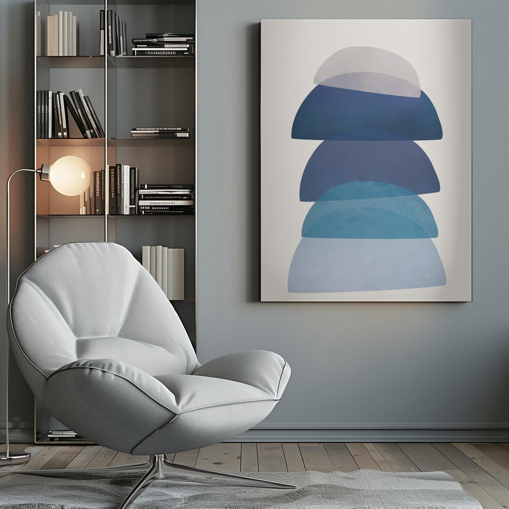 An abstract art print in a black frame, featuring a vertical stack of five semi-circular, dome-like shapes against an off-white background. The shapes are in various shades of blue and gray and have a translucent, overlapping quality, creating a sense of depth and balance. Artwork