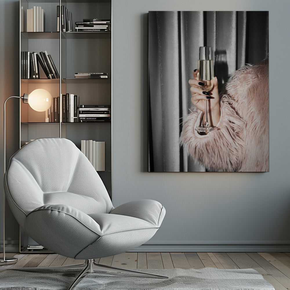 A close-up photograph of a woman's hand with black nail polish holding a tall, elegant flute of champagne. She is wearing a soft, shaggy pink faux fur coat, with a silver-gray curtain in the background, creating a luxurious and celebratory mood. Print