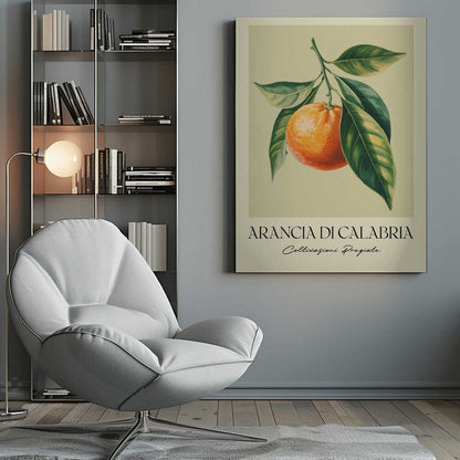 A vintage-style botanical illustration of a ripe orange hanging from a branch with lush green leaves, set against a pale yellow background. Below the image, the text 'ARANCIA DI CALABRIA' is printed in a serif font, with 'Coltivazioni Pregiate' in a script font underneath. The entire print is framed in black. Artwork