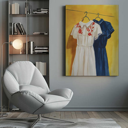 A painting of two vintage-style dresses hanging on a clothesline against a bright yellow wall. The dress in the foreground is white with red floral embroidery on its collar, and the dress behind it is a solid dark blue. Decor