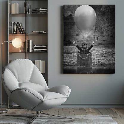 A whimsical black and white photograph of a young girl wearing an aviator cap and goggles, joyfully raising her arms in the air while standing in a wicker basket attached to a large balloon, mimicking a hot air balloon. The scene is set by the water with a stone wall in the background. Poster