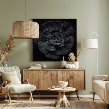 A framed black and white, top-down photograph of a succulent. The intricate, textured leaves of the plant form a perfect rosette, creating a strong contrast against the solid black background. Poster