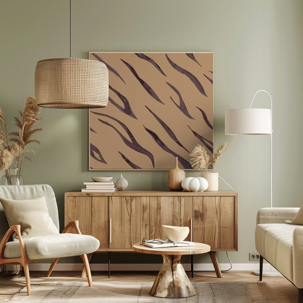 A framed piece of art featuring an abstract pattern of dark, purplish-brown tiger stripes painted in a watercolor style, arranged diagonally on a solid tan background, all enclosed within a light wood frame. Decor