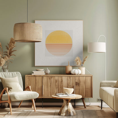 A framed minimalist art print featuring a large circle against an off-white background. The top half of the circle is a solid textured yellow, while the bottom half consists of horizontal orange stripes that gradually become thinner towards the bottom, evoking a stylized sun or sunset. The artwork is surrounded by a wide white mat and a light wood frame. Decor