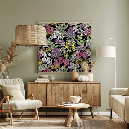 A vibrant, hand-drawn floral pattern of colorful orchids in pink, purple, yellow, and white. The dense botanical illustration, with its lush green leaves, is set against a stark black background, all enclosed within a light wood frame. Artwork