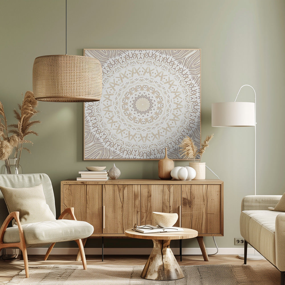 A framed square artwork featuring a detailed mandala design in neutral tones. The intricate pattern consists of concentric circles with geometric shapes like 'X's and chevrons, rendered in shades of beige and taupe on a white background, all enclosed in a light-colored wooden frame. Decor