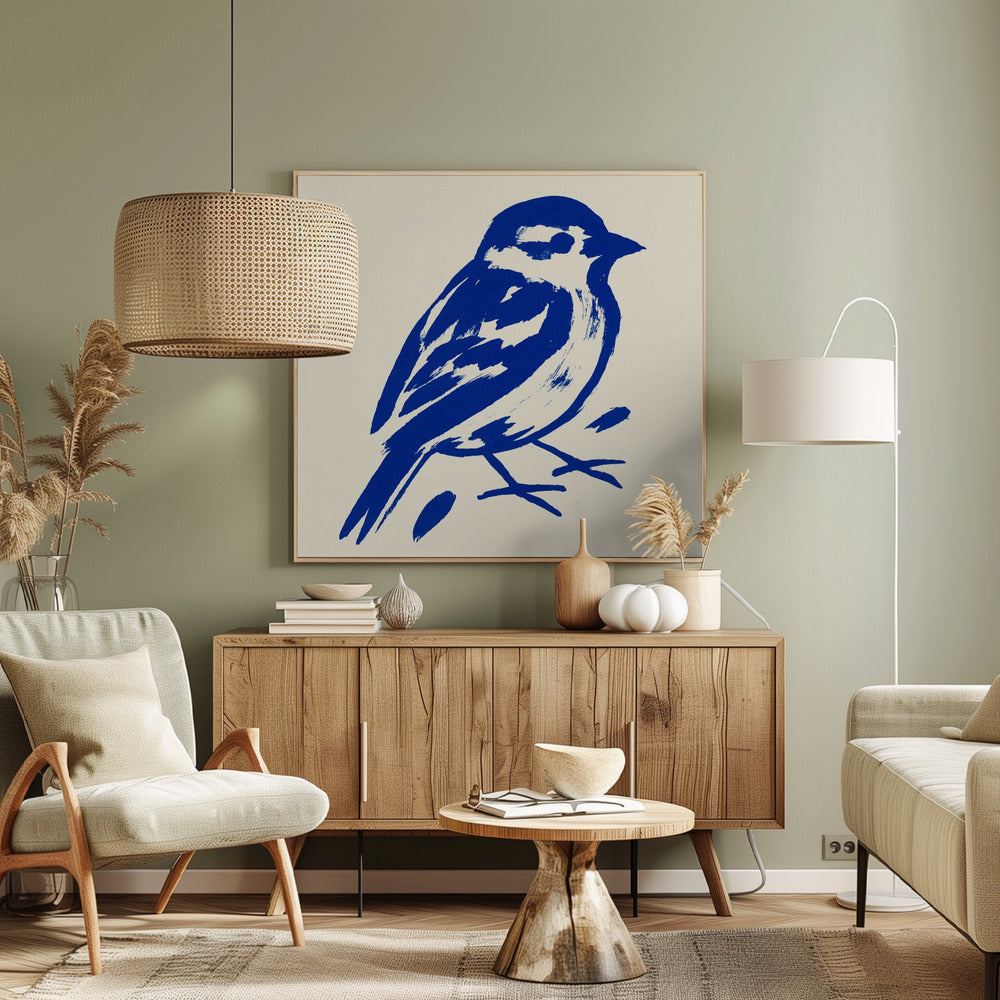 A stylized art print of a small bird, possibly a sparrow, rendered in bold cobalt blue ink with expressive brushstrokes. The bird is set against a solid cream background and enclosed in a light wood frame. Print