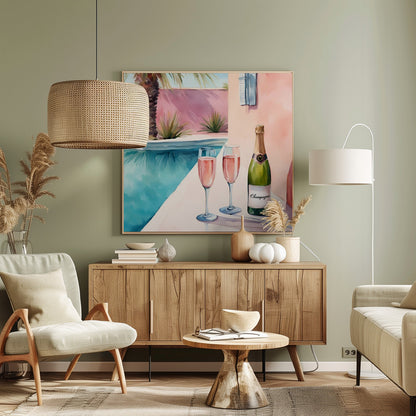 A watercolor illustration of a bottle of champagne and two glasses of rosé resting on the edge of a bright turquoise swimming pool. In the background, a pink wall is adorned with a palm tree, creating a sunny, luxurious vacation scene, all presented in a light wood frame. Artwork