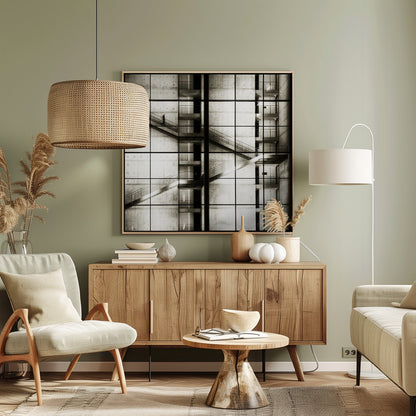 A framed black and white photograph of a modern concrete building's interior, seen through a grid of window panes. The image captures multiple levels of staircases and walkways crisscrossing in a complex, geometric pattern. A shadowy, blurred figure of a person can be seen walking up a staircase on the upper left. Wall Art