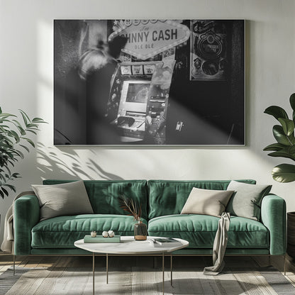 A grainy, black and white photograph of a person blurred by motion standing in front of a Johnny Cash themed slot machine. A lit marquee sign above the machine reads "HELLO I'm JOHNNY CASH OLÉ OLÉ". The setting appears to be a dark bar or casino. Wall Art