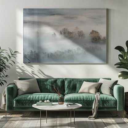 An atmospheric landscape photograph of a forest shrouded in thick, rolling fog, with the bare branches of treetops emerging from the mist, creating a serene and mysterious scene, presented in a silver frame. Wall Art