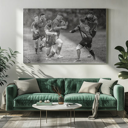 A dynamic black and white photograph of a rugby match being played in the rain. One player charges forward with the ball while an opponent wraps his arms around him in a tackle. Other players are in motion around them, capturing the intensity and physicality of the sport. Decor