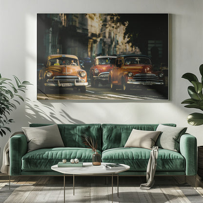 Three vintage American cars drive down a sunlit city street. The foreground features an orange taxi, with a red car and another orange vehicle behind it, all under the warm glow of late afternoon light casting long shadows. Print