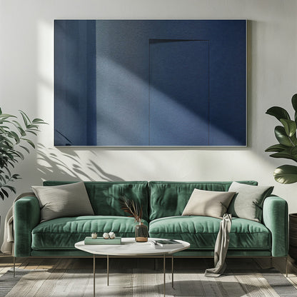 An abstract geometric artwork featuring textured panels in various shades of deep and dusty blue. The composition is divided into vertical sections, with a central rectangular shape that appears slightly recessed, creating a strong shadow line at its top edge. The piece is enclosed in a simple, brushed silver frame. Wall Art