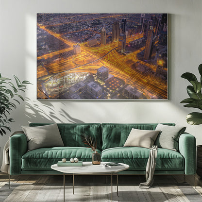 A stunning aerial view of a futuristic city at night, with brilliantly lit highways forming intricate patterns of golden light amidst towering skyscrapers, enclosed in a silver frame. Poster
