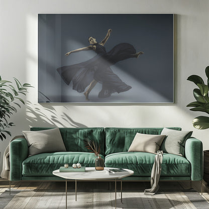 A framed photograph of a graceful female dancer in a dramatic pose, her long, dark blue, flowing dress billowing around her against a muted blue-gray studio background. Wall Art