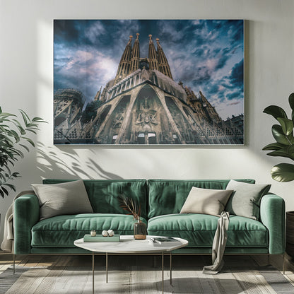 A dramatic, low-angle photograph of the Sagrada Familia in Barcelona, with its ornate stone facade and towering spires reaching up into a turbulent, dark blue and cloudy sky. The perspective emphasizes the grand scale and intricate detail of Gaudí's architecture. Print