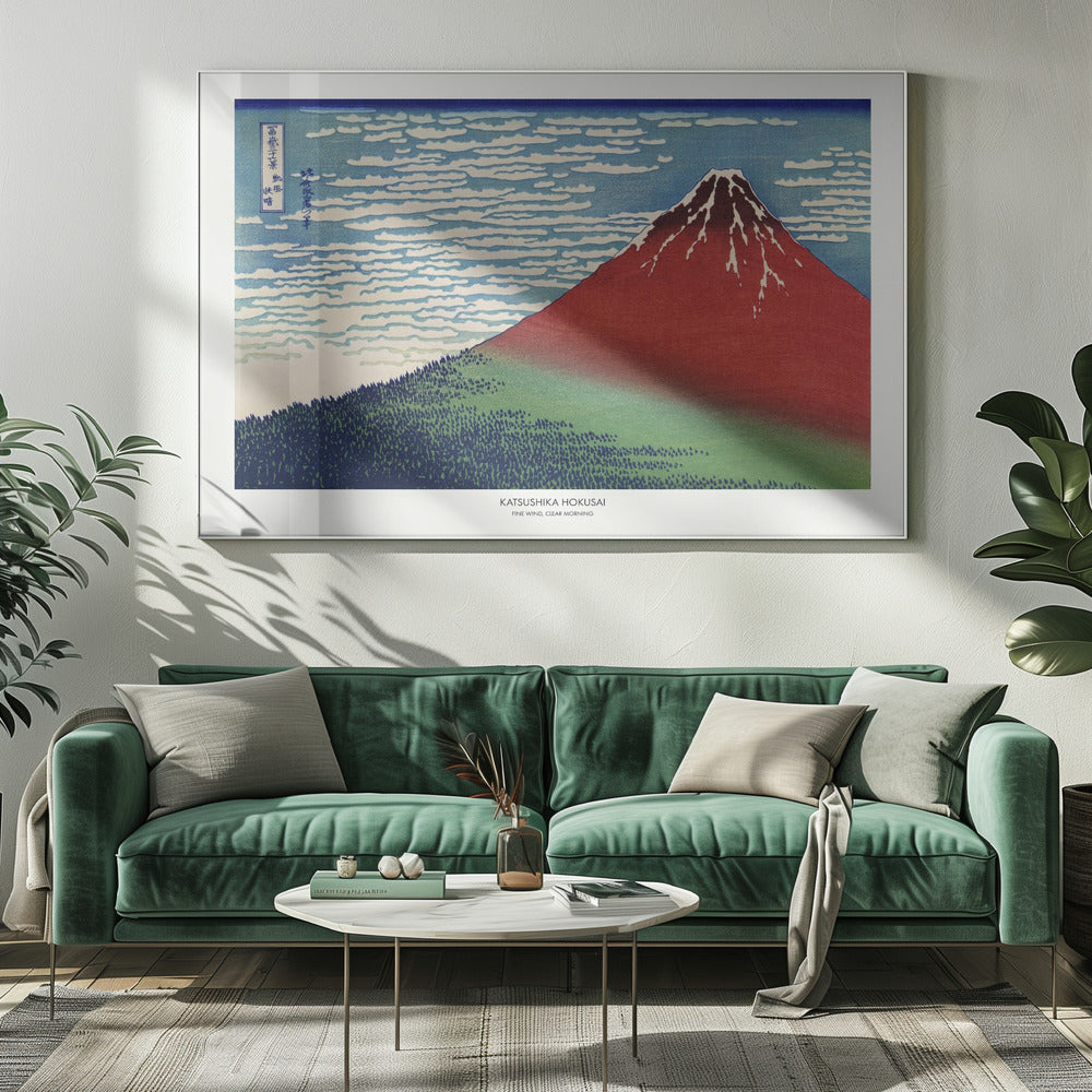 A framed Japanese woodblock print, 'Fine Wind, Clear Morning' by Katsushika Hokusai, also known as 'Red Fuji'. The print depicts a large, reddish-brown Mount Fuji with its peak lightly dusted with snow, set against a vibrant blue sky filled with white, streaky clouds. A dark green forest covers the base of the mountain. Poster