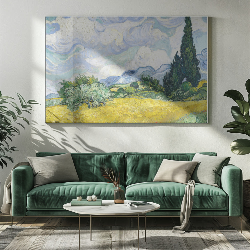 A framed print of Vincent van Gogh's painting 'Wheat Field with Cypresses.' The artwork depicts a vibrant golden wheat field under a dynamic sky filled with swirling white and blue clouds. A tall, dark green cypress tree dominates the right side, with rolling green hills and distant blue mountains in the background. Decor