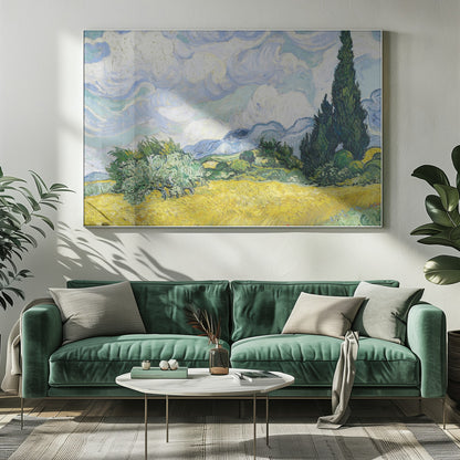 A framed print of Vincent van Gogh's painting 'Wheat Field with Cypresses.' The artwork depicts a vibrant golden wheat field under a dynamic sky filled with swirling white and blue clouds. A tall, dark green cypress tree dominates the right side, with rolling green hills and distant blue mountains in the background. Decor