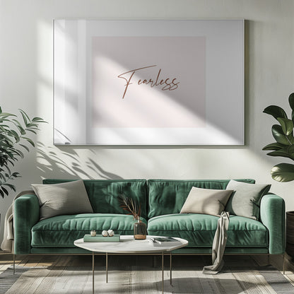 A framed artwork featuring the word 'Fearless' in a flowing brown script font on a pale pink background. The piece is surrounded by a white mat and a textured silver frame. Wall Art
